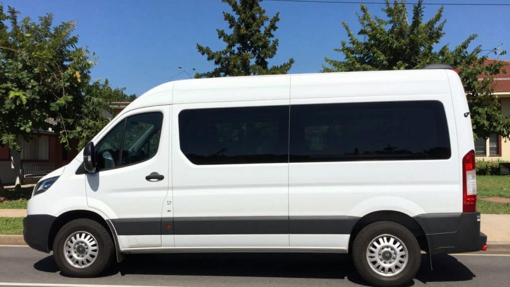 Church van parked on a sunny street.